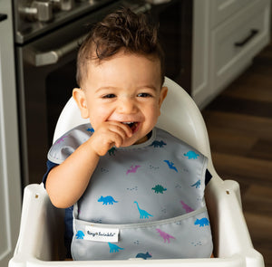 baby boy using Tiny Twinkle's Dinosaur Easy Bib
