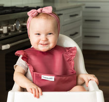 Load image into Gallery viewer, baby girl using the Tiny Twinkle&#39;s Easy Bib with Ruffles in Burgundy 

