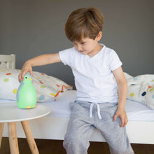 Load image into Gallery viewer, Zazu - Pam the Penguin Sleeptrainer blue in green light

