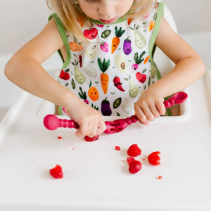 Toddler using BapronBaby Market Fresh Produce Bapron Bib-Apron
